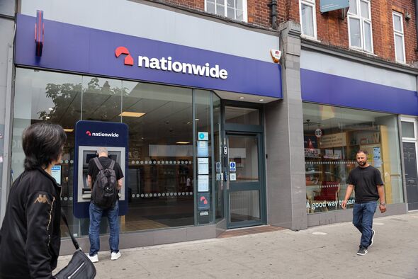 People walk past a Nationwide branch
