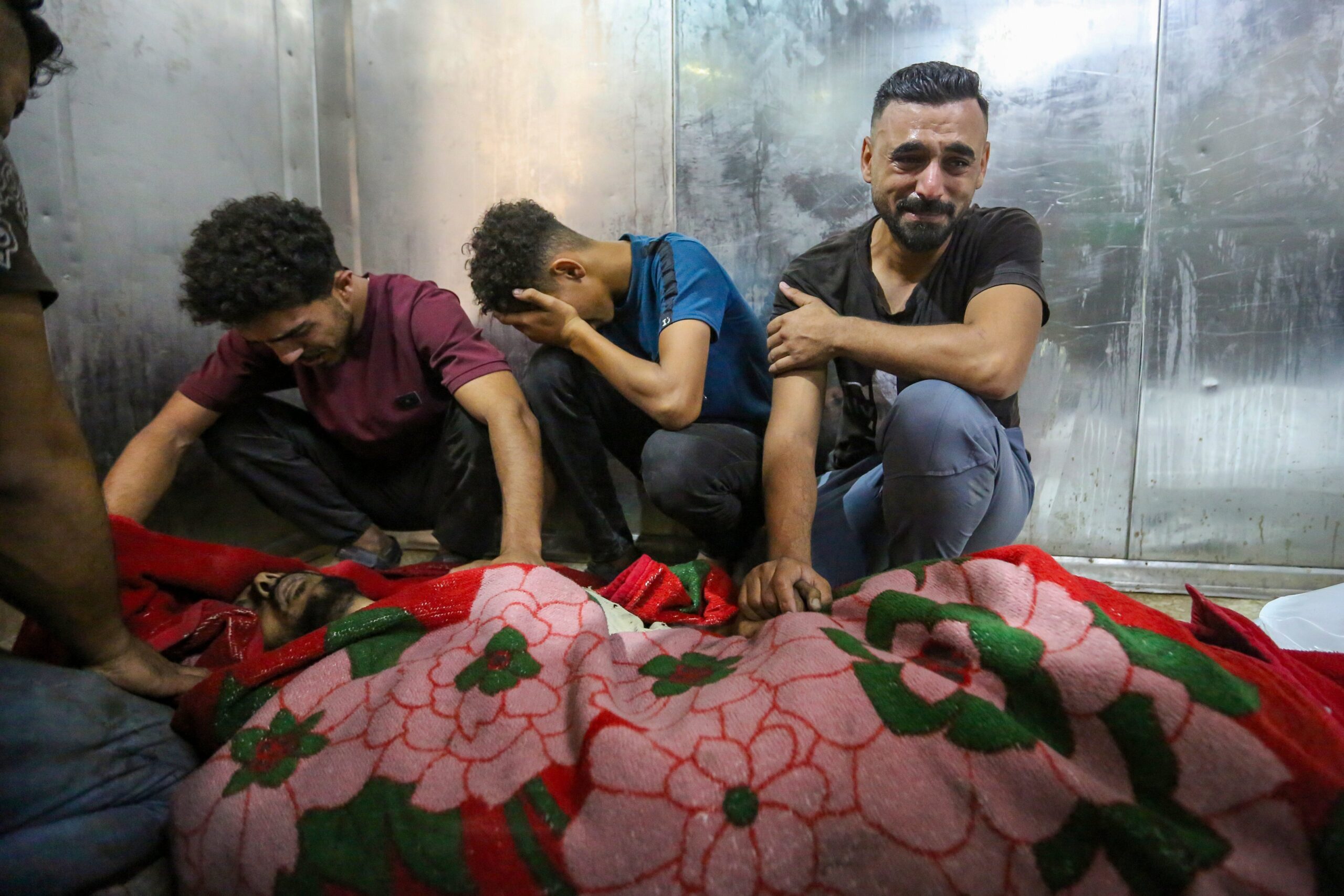 GAZA CITY, GAZA - JUNE 14: (EDITOR'S NOTE: Image depicts death) Family and friends mourn a victim, killed in an Israeli airstrike at Al-Shifa hospital on June 14, 2026 in Gaza City, Gaza. A fan repair shop in the Jabaliya area of Gaza City was reportedly targeted in an alleged Israeli strike, killing four people and injuring five others. Israel has continued to bomb Gaza despite the US-brokered ceasefire deal, accusing Hamas of rearming and rebuilding its forces. (Photo by Ahmad Hasaballah/Getty Images)