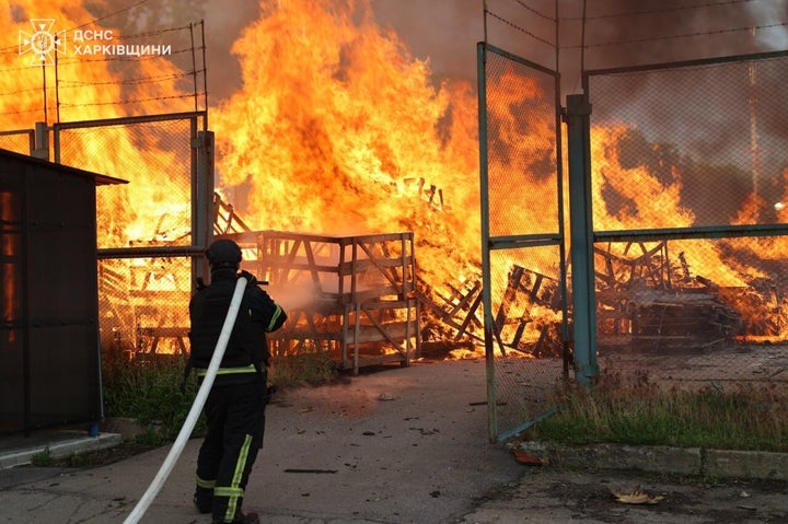 In this photo provided by the Ukrainian Emergency Services on June 2, 2026, a rescue worker puts out a fire of a storage facility after a Russian strike on Kharkiv region, Ukraine.