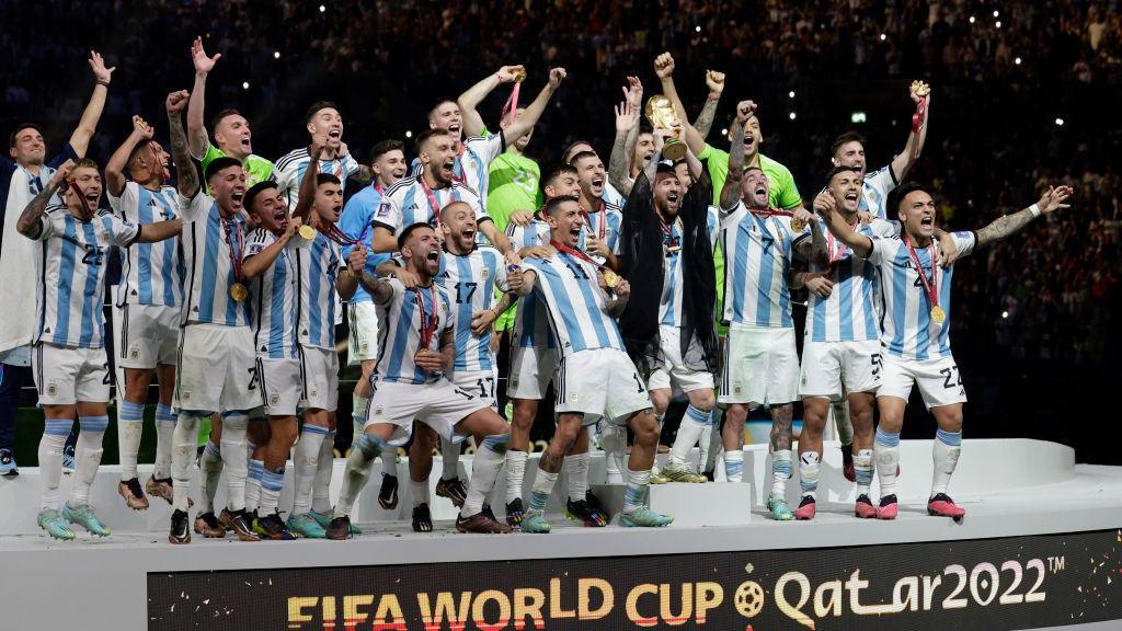 The Argentina squad celebrates with Lionel Messi lifting the Fifa World Cup trophy in Qatar