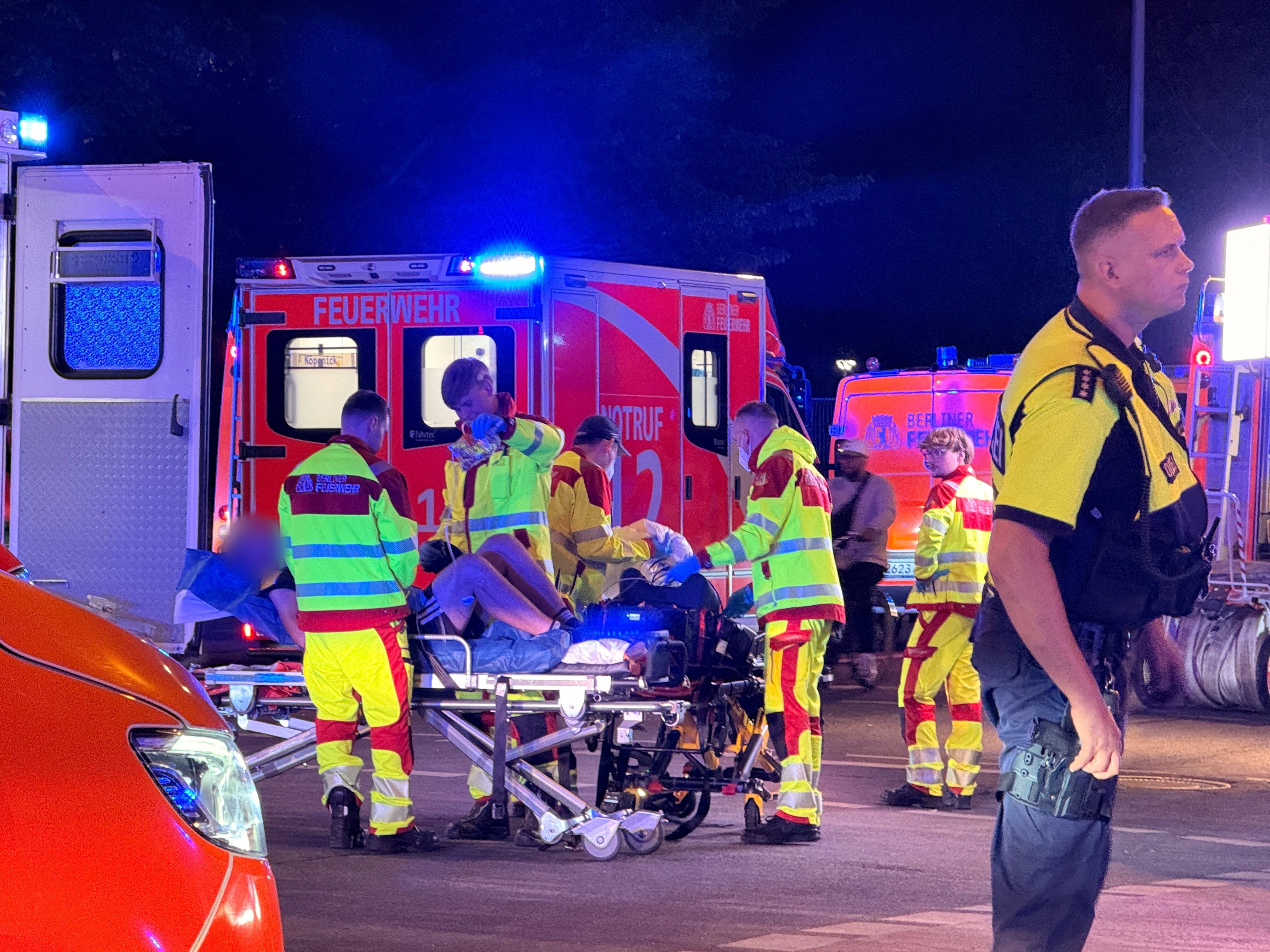 Firefighters treat an injured person by the site of an attack on the Pride festival in Berlin, Germany, on Saturday. (Photo by Andreas Rabenstein/picture alliance via Getty Images)