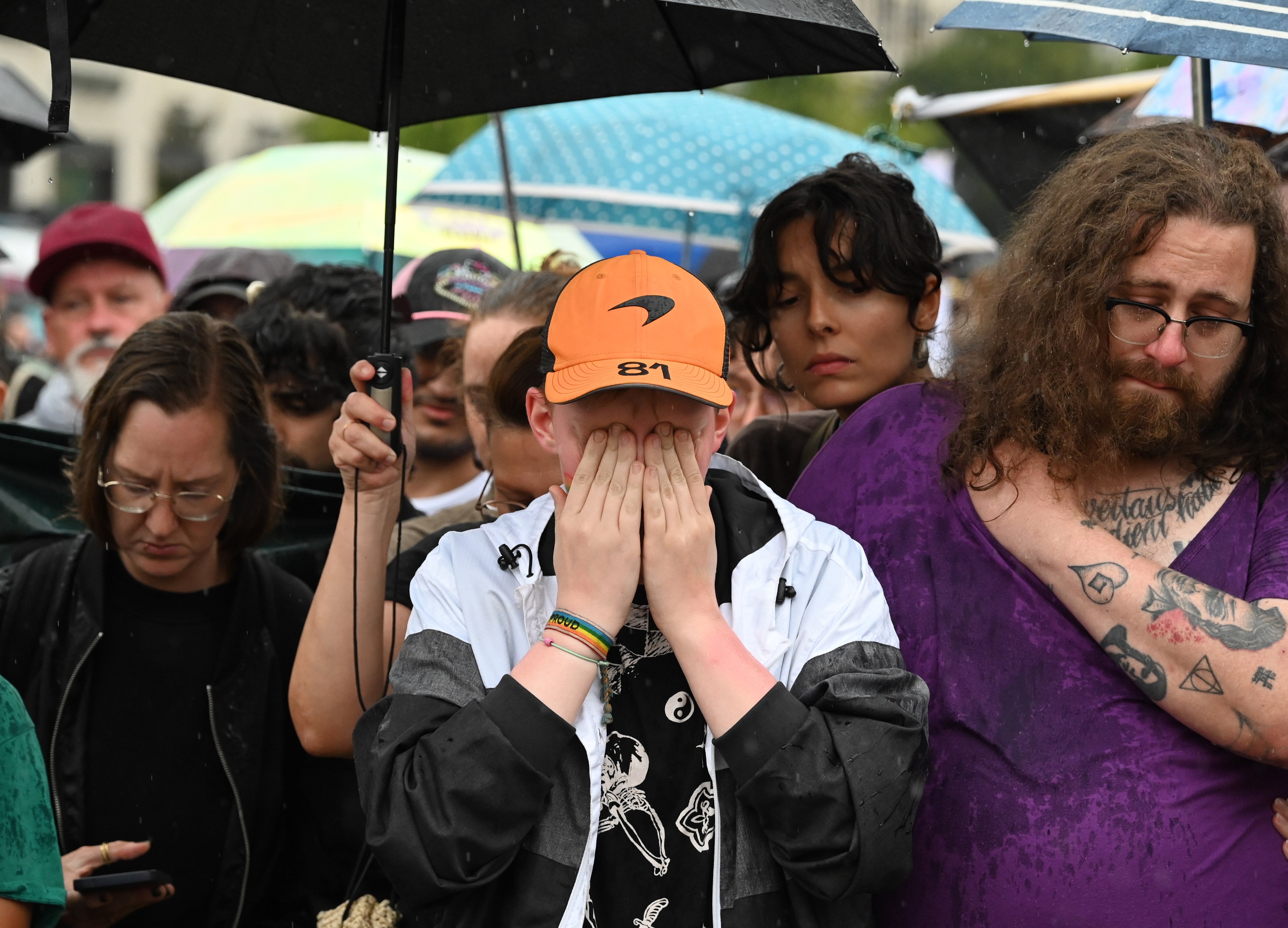 People mourn near the Brandenburger Gate, not far from the scene where a vehicle plowed into a crowd during the Christopher Street Day parade, in Berlin, Germany, this weekend. (Photo by Volodymyr Sindieiev/Anadolu via Getty Images)
