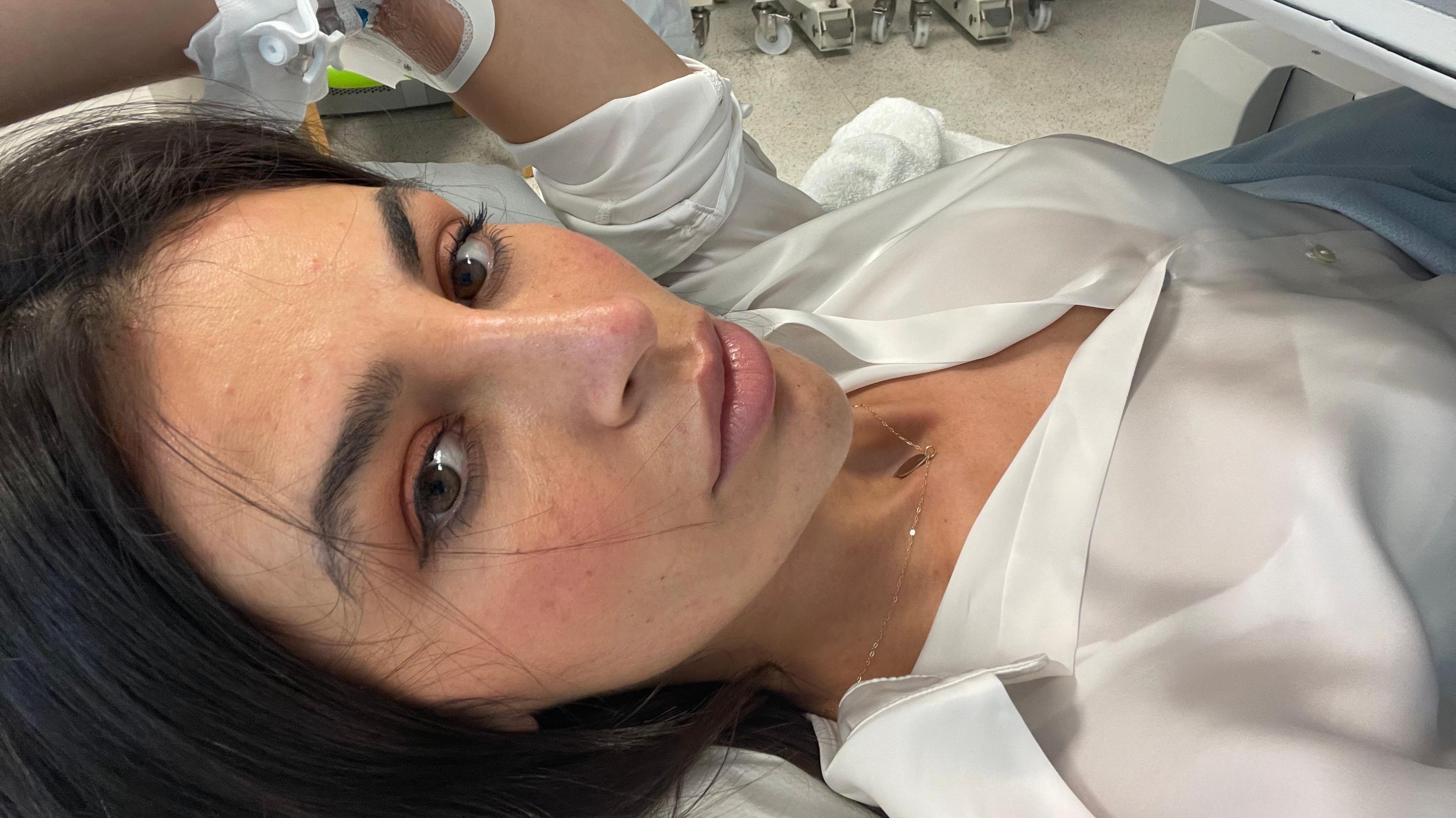 Carla lying on a hospital bed