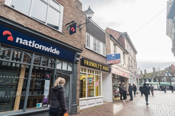 A person walks past a Nationwide branch A person walks past a Nationwide branch