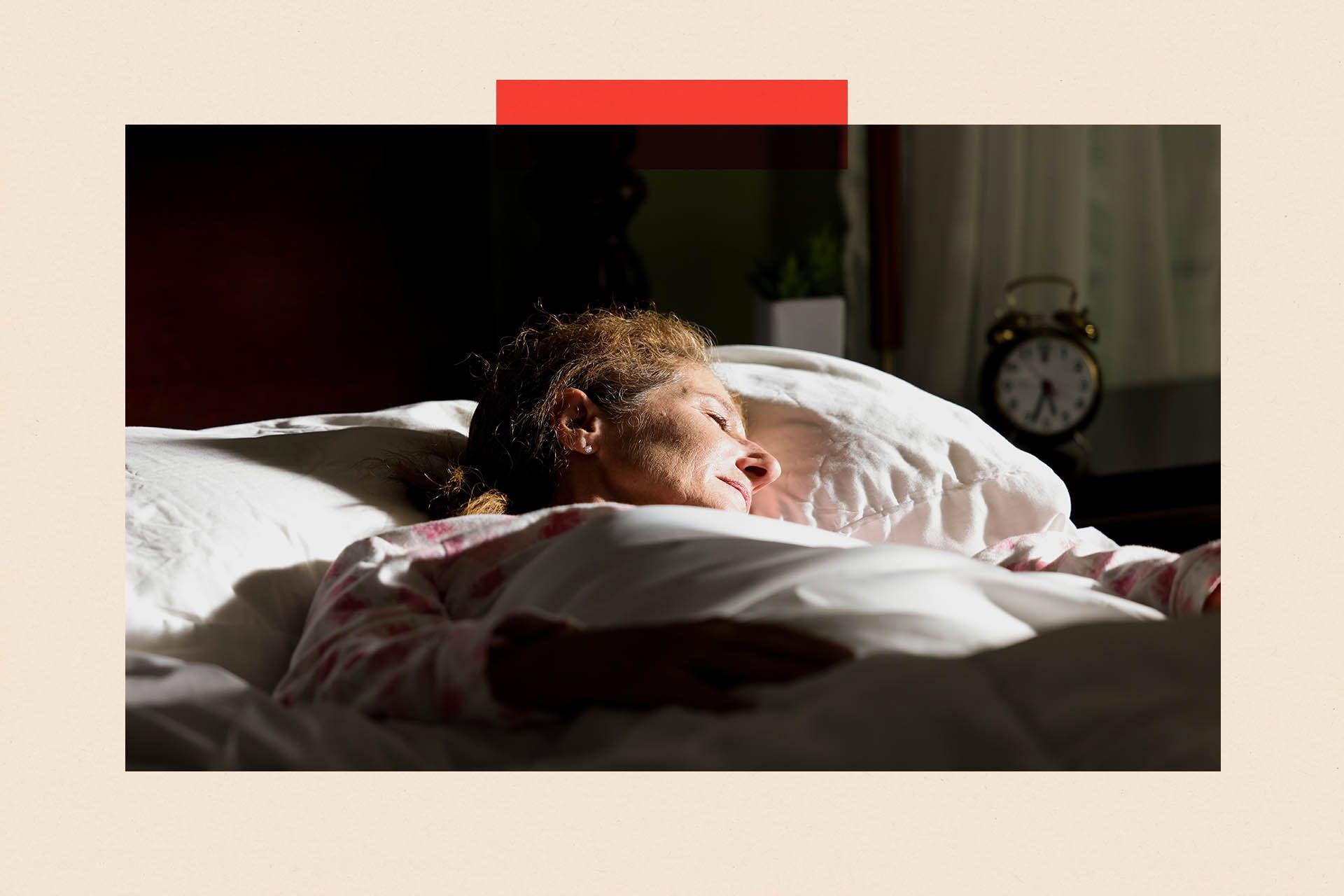 A woman trying to sleep as the sun shines on her bed