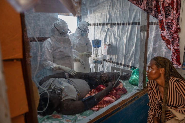 Health workers tend to an Ebola patient at the Rwampara Treatment Center in Ituri, Congo, on June 18.