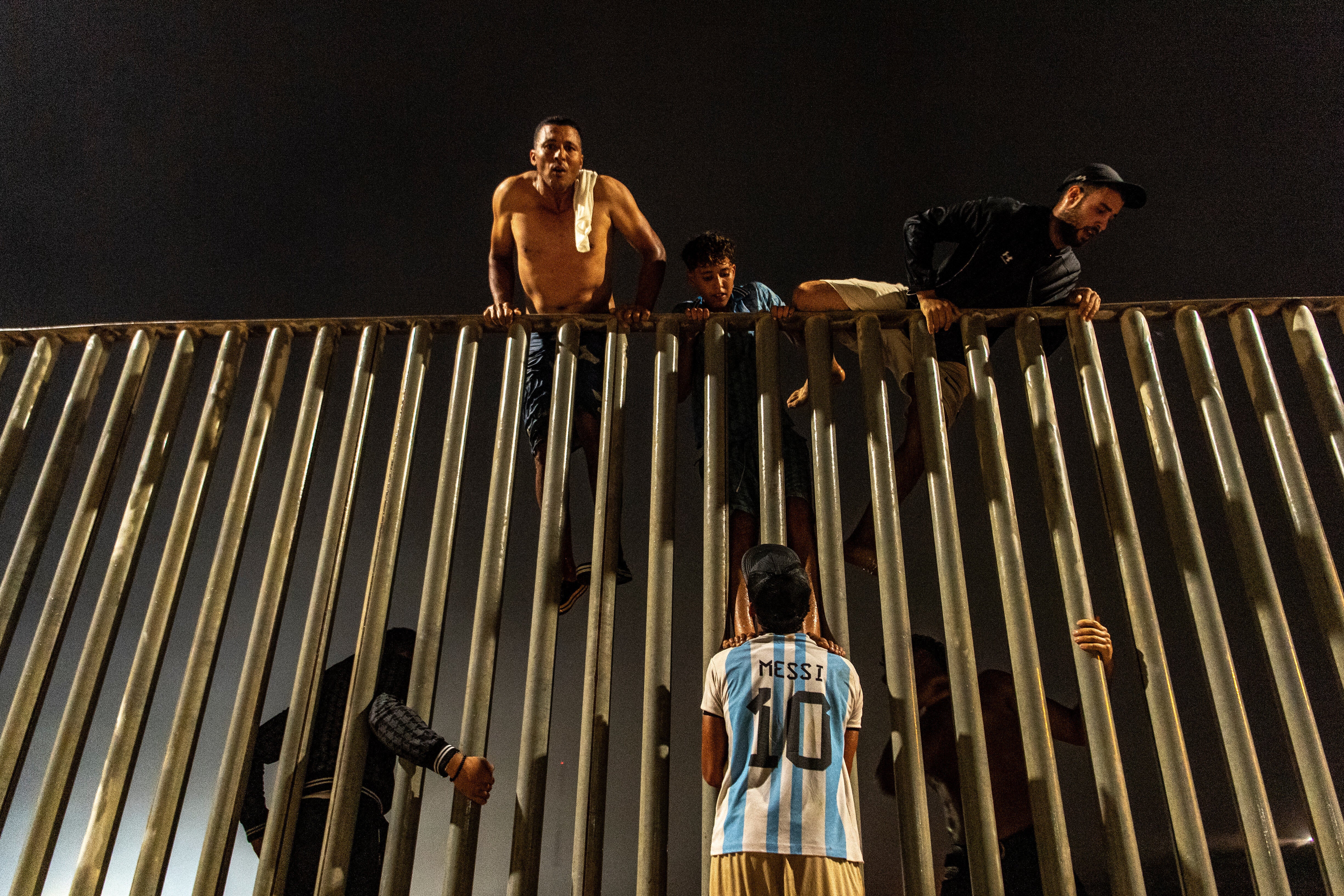 Migrants try to cross from Morocco into the Spanish enclave of Ceuta, Friday, July 31, 2026. (AP Photo/Antonio Sempere)