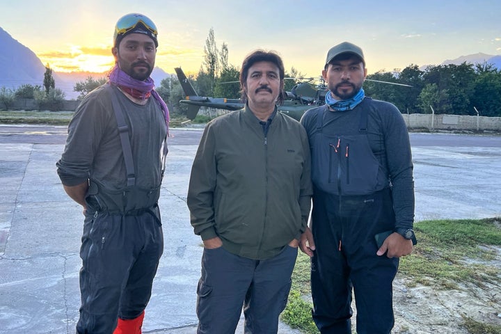 In this photo released by the Alpine Club of Pakistan on Friday, July 31, 2026, members of a mountaineers rescue team pose for photo with honorary general secretary of Alpine Club of Pakistan Ayaz Ahmed Shigri, center, before departing from an airbase on a search operation for climbers missing after an avalanche on Pakistan's Broad Peak, in Skardu, in Gilgit-Baltistan's region, in northern Pakistan. (Alpine Club of Pakistan via AP)