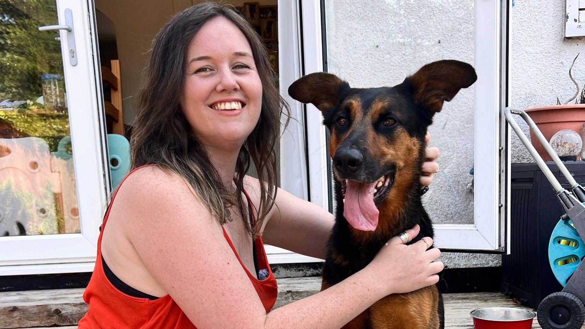 A woman hugging her spanish rescue dog