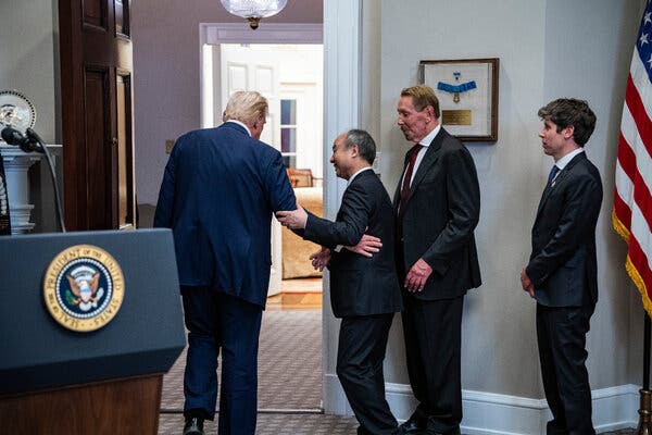 President Trump with three men in business suits leaving a room with a lectern with the presidential seal.