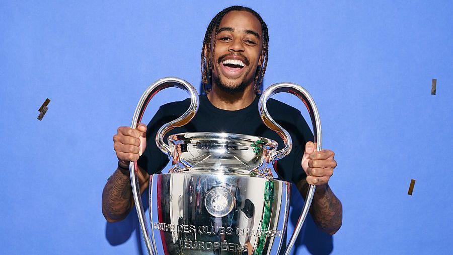 Bradley Barcola holding the Champions League trophy