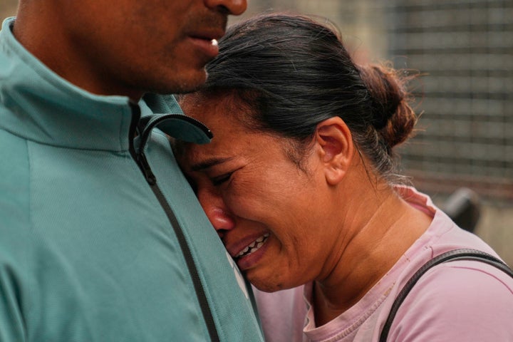 A relative consoles Sabina Dangal outside a government hospital as she waits for news of her brother, who is missing after flash floods, in Kathmandu, Nepal, Friday, Aug. 28, 2026. (AP Photo/Dar Yasin)