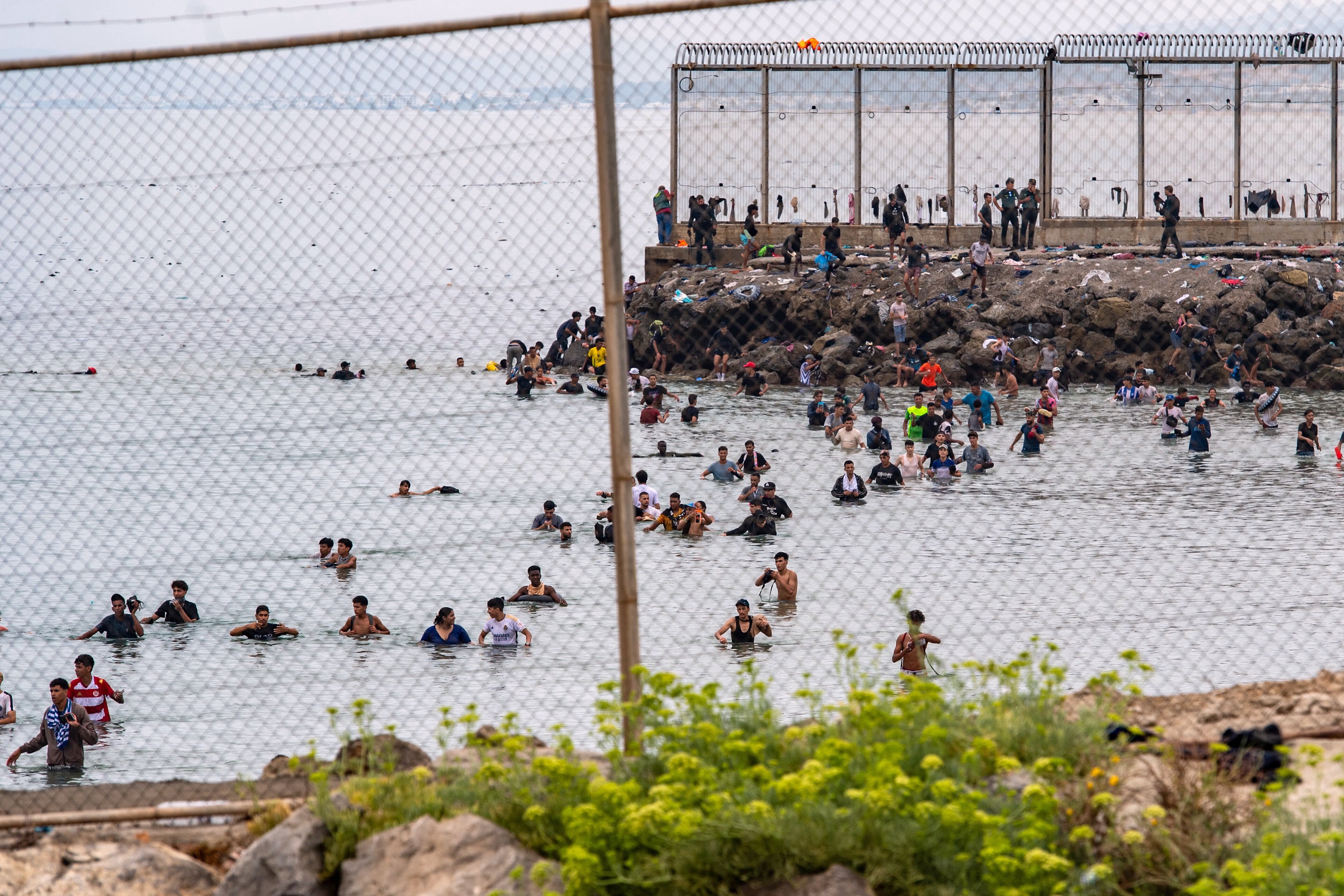 Migrants try to cross from Morocco into the Spanish enclave of Ceuta on Friday.