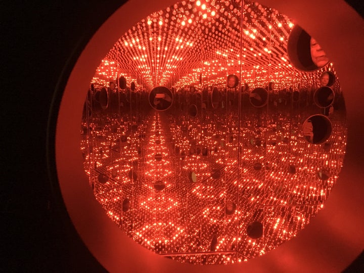 In this Nov. 21, 2017 photo, colored lights appear in the Infinity Mirror Room created by Japanese artist Yayoi Kusama, part of the exhibit, "Yayoi Kusama: Festival of Life," on display at the David Zwirner gallery in the Chelsea section of New York. (AP Photo/Jocelyn Noveck)
