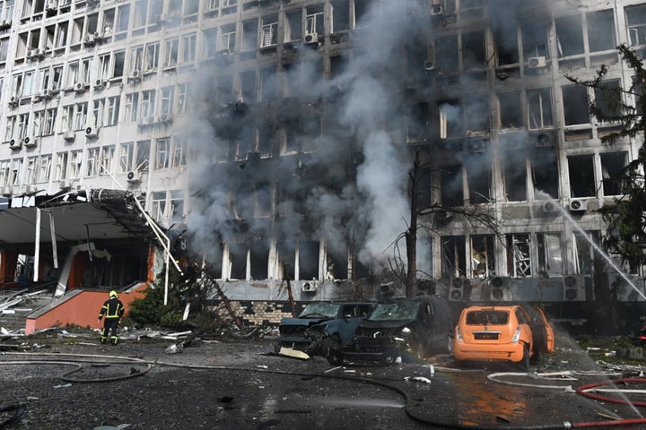 Firefighters work at the site of a business center in Kyiv hit by a Russian drone strike. At least eight people were injured by Russia’s massive shelling of Kyiv, and one died in the hospital. Explosions echoing across downtown Kyiv every 15 to 30 minutes.