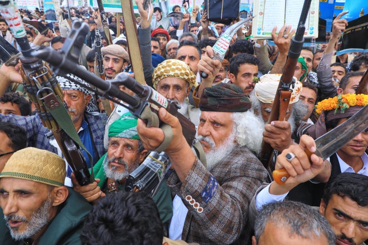 Supporters of Yemen’s Houthi rebels raise their rifles during a rally in support of the group and to protest Saudi Arabia’s accusation that the Houthis targeted Islam’s holiest site of Mecca, in Sanaa, Yemen, Friday, Sept. 18, 2026. (AP Photo/Osamah Abdulrahman)
