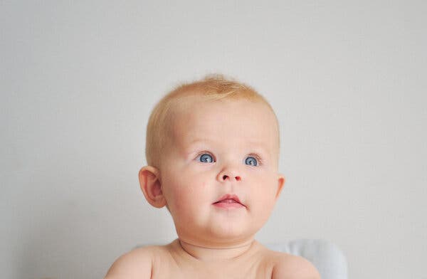 A portrait of a baby with bright blue eyes.