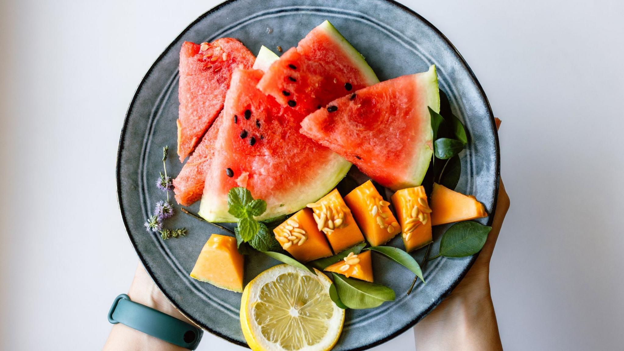 Watermelon and cantaloupes slices on a plate, including skin and pips