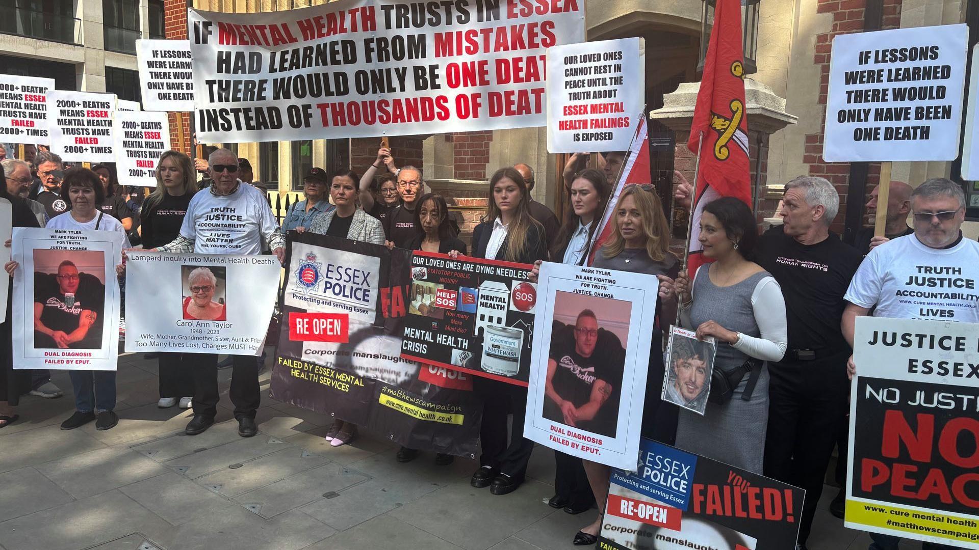 Protesters outside Arundel House in London, where the Lampard Inquiry previously took place. Many are holding pictures of their loved ones or signs asking for justice. There are around 20 people in the picture