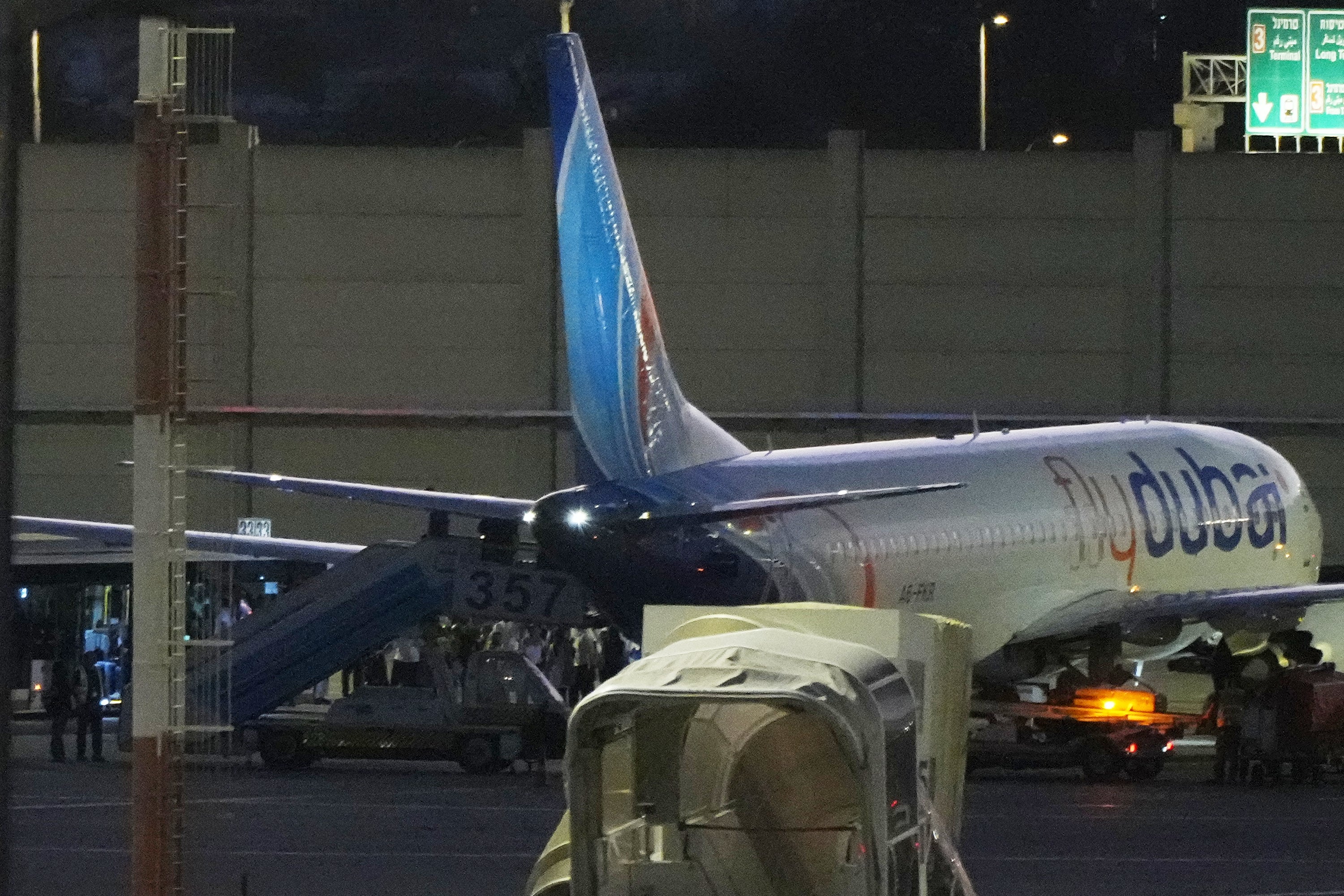 People disembark from a FlyDubai carrying Israeli passengers who had earlier been aboard another FlyDubai aircraft that made an emergency landing in Saudi Arabia approaches Ben Gurion International Airport near Tel Aviv, Israel, Wednesday, Sept. 30, 2026. (AP Photo/Ariel Schalit)