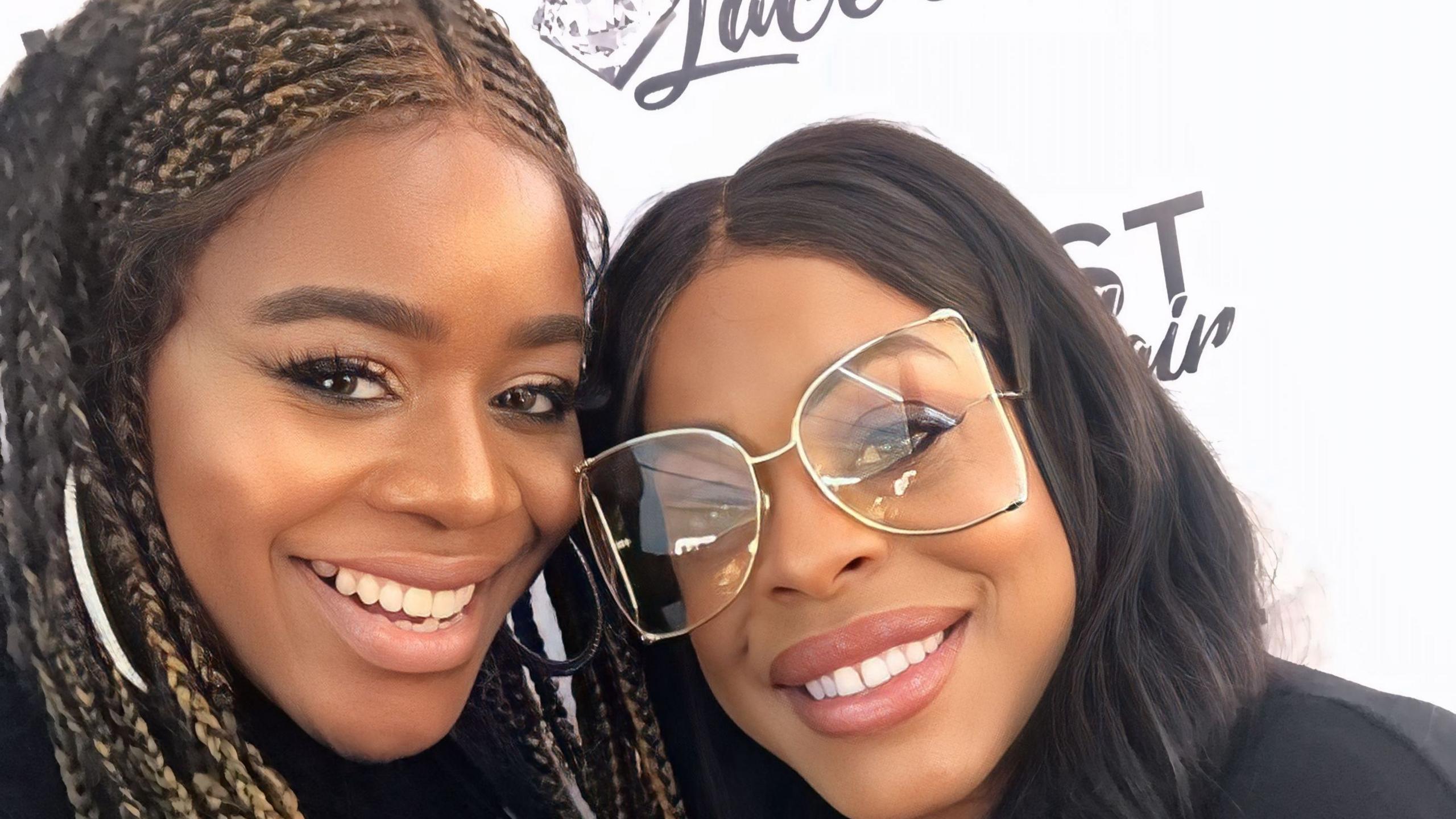 A close-up selfie of Antonia and actress Niecey Nash. Both are smiling and Niecey, who is on the right, is wearing a large pair of clear glasses. Her hair is black and long.