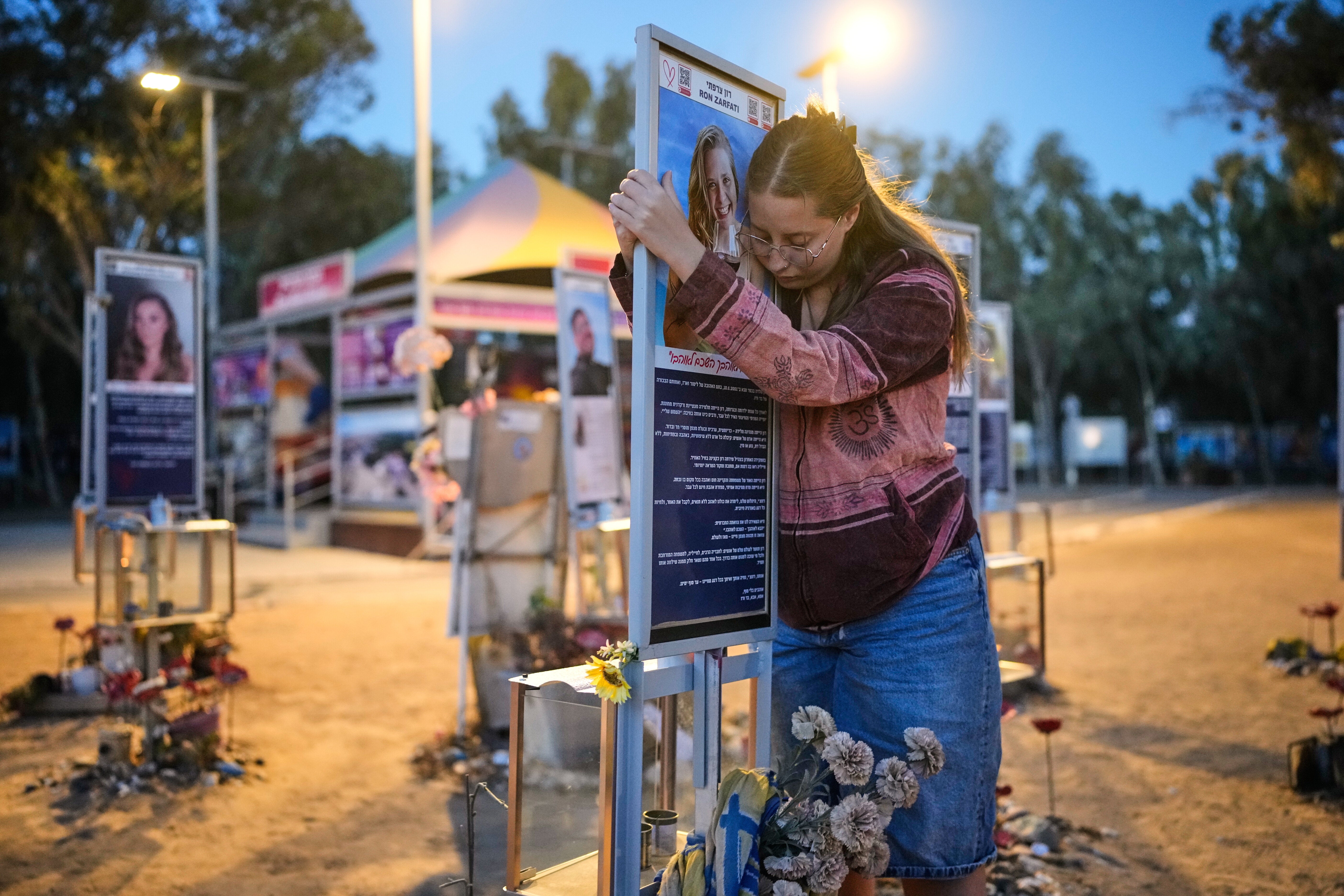 Raz Zarfati, sister of Ron Zarfati who was killed in the Oct. 7, 2023, Hamas-led attack on Israel, attend a memorial marking the third anniversary of the attack at the Nova music festival site near Kibbutz Reim, southern Israel, Wednesday, Oct. 7, 2026. (AP Photo/Ohad Zwigenberg)