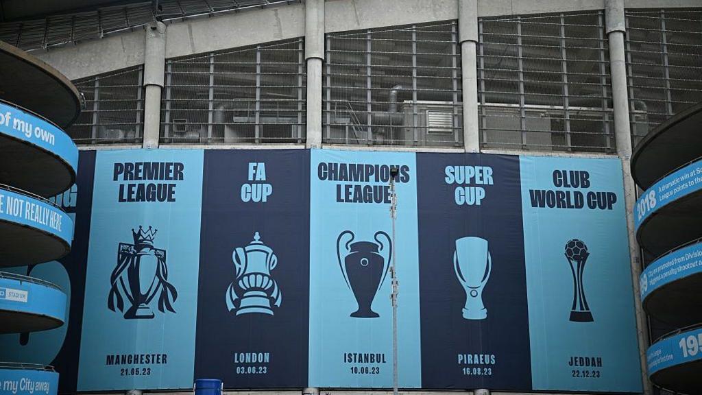 Images of trophies won are pictured outside the Etihad Stadium, the home ground of Manchester City football club