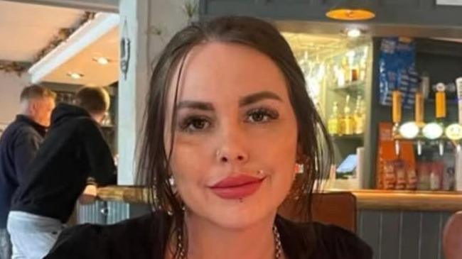 Alice Webb is looking at the camera. She has dark brown hair tied back from her face and a lip and nose piercing
